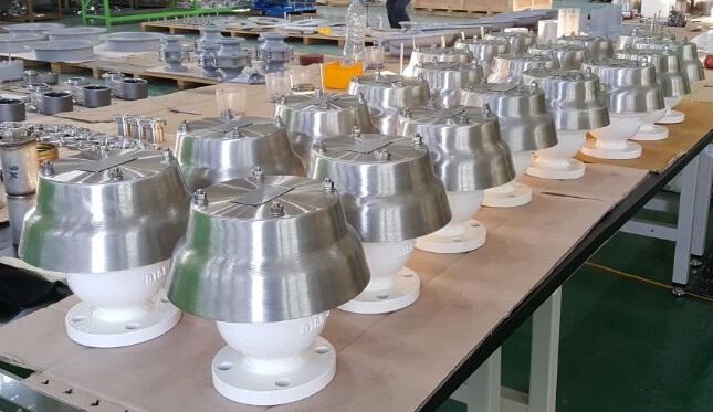 Batch of white coated industrial valves after external coating application